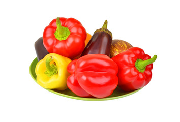 Eggplant and bell pepper on plate, isolated on white background