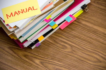Manual; The Pile of Business Documents on the Desk