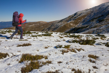 Fototapeta premium The climber comes to a high mountain.