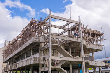 Building construction site in progress against blue sky