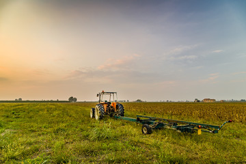 Fototapeta premium tractor and harvested land
