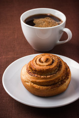  cinnamon roll bun  and cuf of coffee