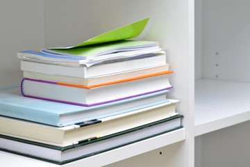 Books on bookshelf/Books on the white wooden bookshelf.