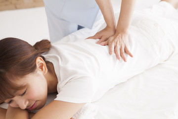 Fototapeta na wymiar Young women are receiving a massage in a prone