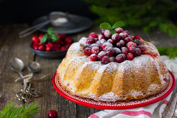 cranberry cake decorated with powdered sugar and fresh berries f