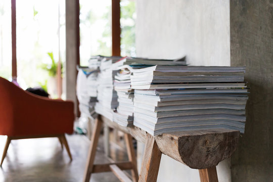 Stack Of Magazine Books On Wooden Table Shelf In Living Room