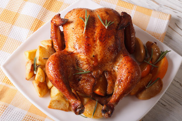roast chicken with oranges, potatoes and apples close-up. horizontal
