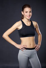 Fototapeta na wymiar Portrait athletic girl on a black background