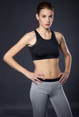 Fototapeta na wymiar Portrait athletic girl on a black background