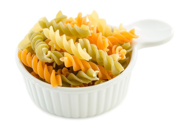 dried italian pasta (macaroni) in white bowl.