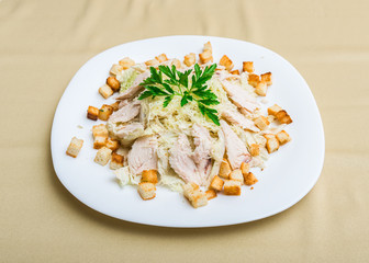 Chicken cheese croutons cabbage salad (focus is in the middle of the dish)