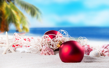 Christmas ornament on a beach,concept of a warm, tropical weather Christmas