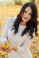 young beautiful girl in the forest. Warm autumn