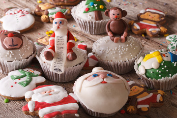 Delicious Christmas cupcakes and gingerbread close up. horizontal
