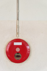 red fire alarm box for warning security system mounted on wall