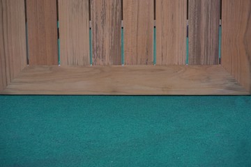 wood board on green carpet