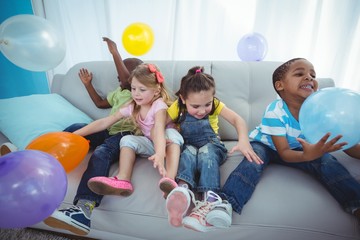 Fototapeta premium Smiling kids playing with balloons