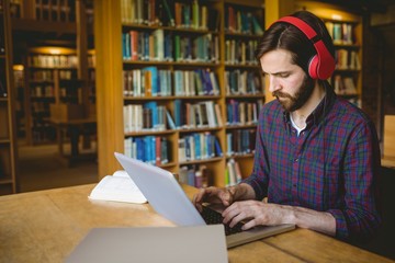 Hipster student studying in library