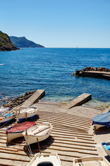 Spanish pier in Majorca. Jetty with little boats. Docked fishing boats in Mallorca