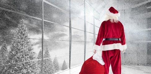 Composite image of santa carrying sack of gifts 