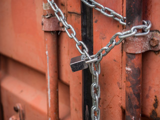 Red container cargo locked by chain