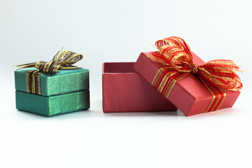 Red festive gift box being opened and left on the side.