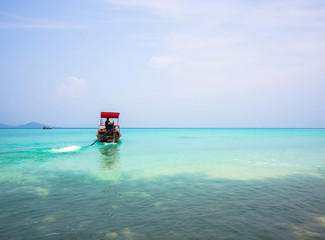 Long-tailed boat heading out to sea