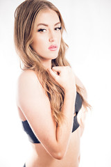 Obraz premium Female fitness model posing in studio. Cinematic Portrait Style.