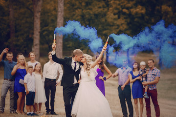 Wedding couple runs blue smoke