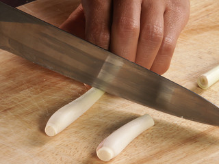 knife cut lemongrass  plant on chopping board by hand 