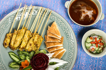 Pork Satay set grill pork in bamboo stick with bread and soybean source and cucumber. 