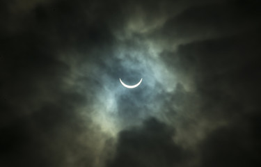Obraz na płótnie Canvas Solar Eclipse Through Thick Clouds