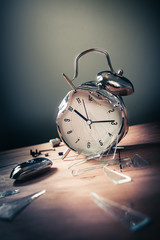 late for work concept with destroyed alarm clock