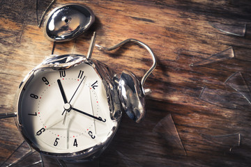 late for work concept with destroyed alarm clock