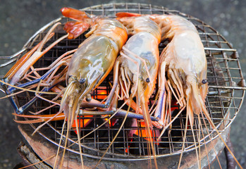 Grilled shrimps on the flaming grill.