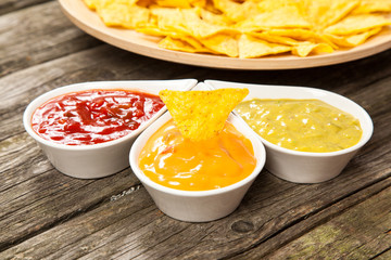 Plate of nachos with different dips