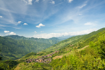 Naklejka na ściany i meble Landscape photo of rice terraces and village in china