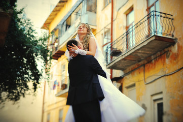 Happy wedding couple walking streets of city