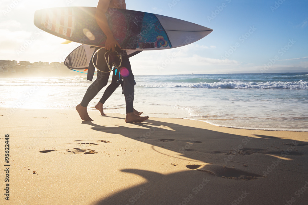 Wall mural Australian surfers walking along Bondi Beach