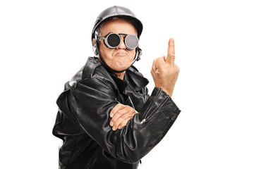 Angry senior biker showing a middle finger