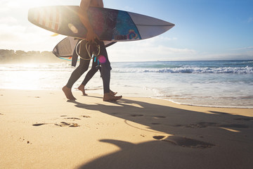 Naklejka premium Australijscy surferzy spacerujący wzdłuż plaży Bondi