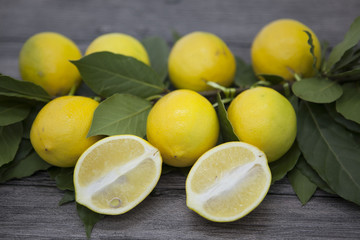 Branch of fresh juicy Sicilian lemons on a wooden background