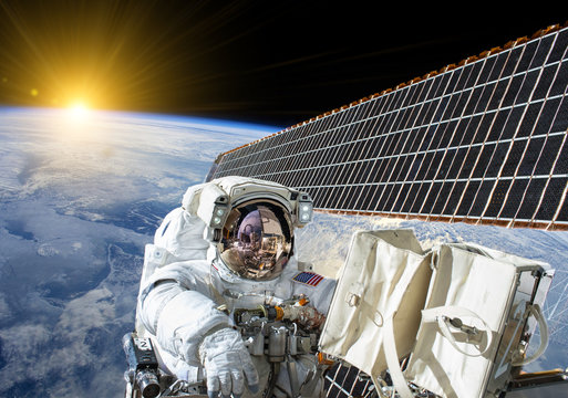 American astronaut on solar cells of the international space station - Elements of this image furnished by NASA