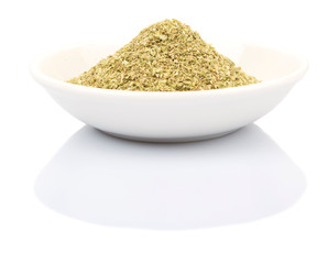 Dried oregano herbs over in white bowl over white background