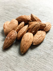 Fine almonds on wooden background
