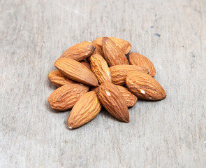 Fine almonds on wooden background