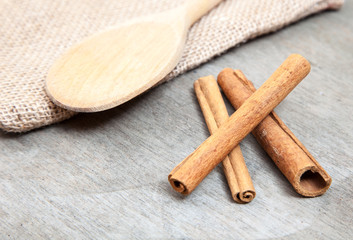 Fine cinnamon sticks on wooden background