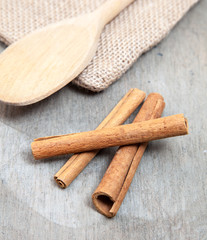 Fine cinnamon sticks on wooden background