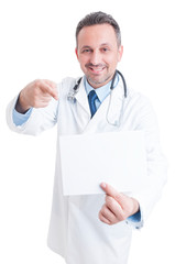 Doctor or medic holding white blank paper with copy space