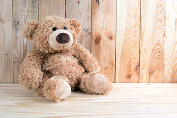 Toy bear on wooden floor
